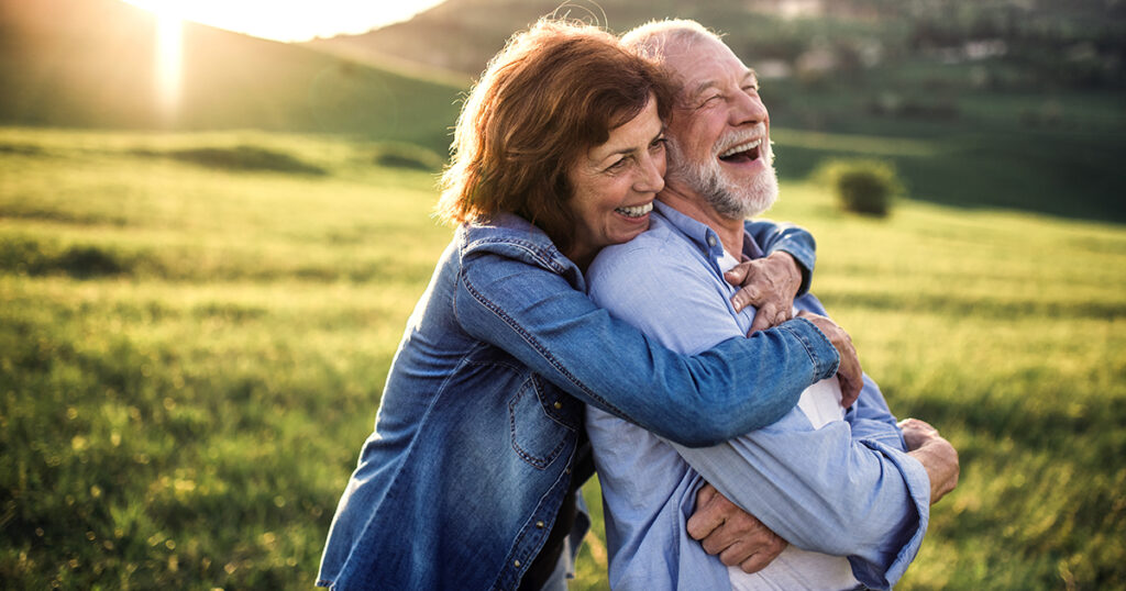 Couple embracing outside and laughing