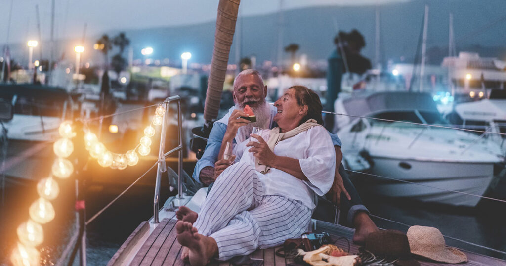 Couple relaxing on boat at harbor during dusk