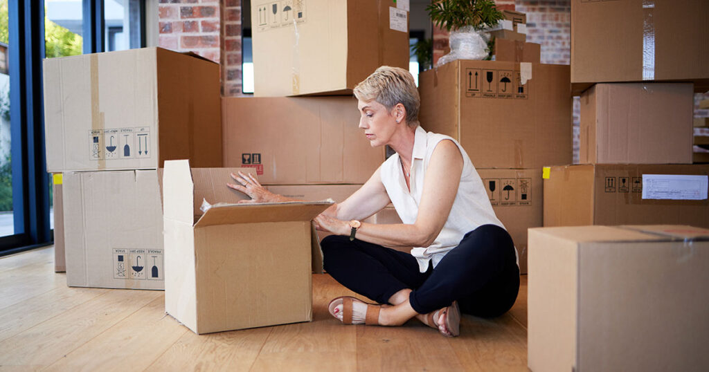 Woman unpacking boxes while moving.