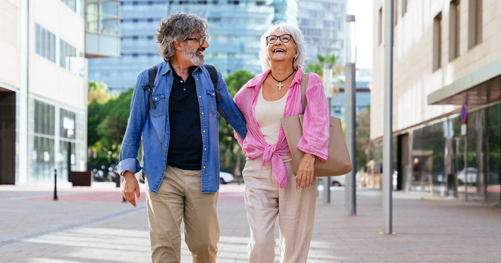 Older couple walking on city street