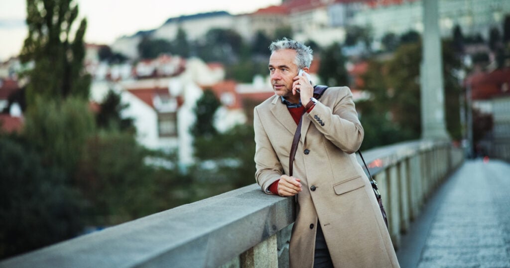 Man traveling abroad and standing on bridge