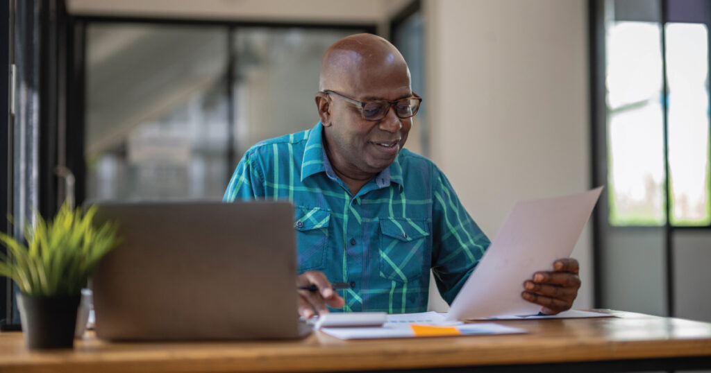 Older man researching on computer