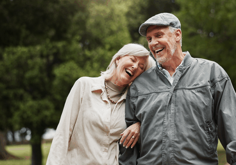 Older jovial couple outside
