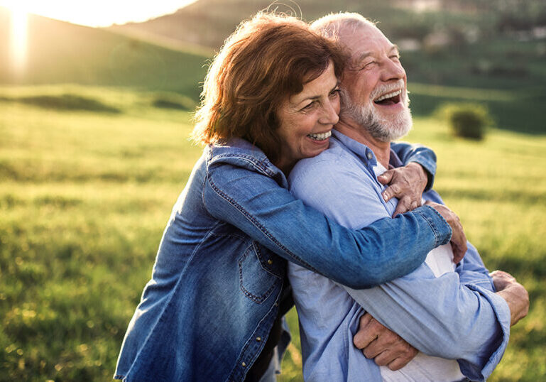 Couple embracing outside and laughing