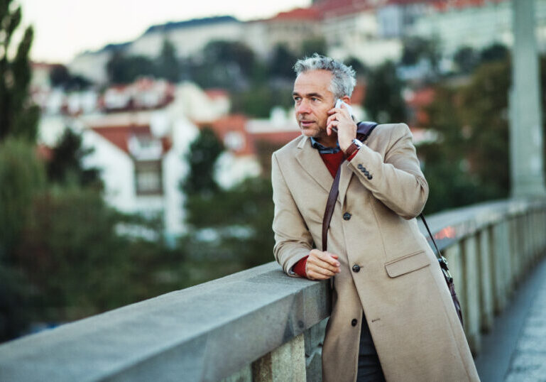 Man traveling abroad and standing on bridge
