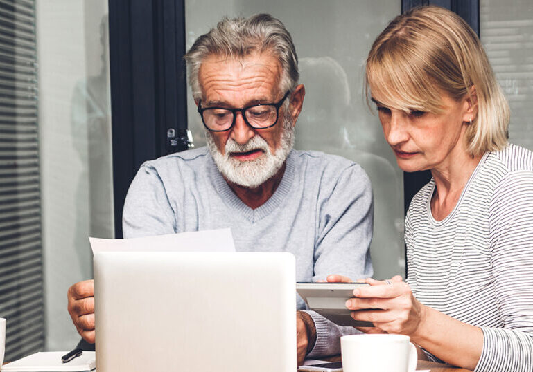 Couple reviewing documents at table