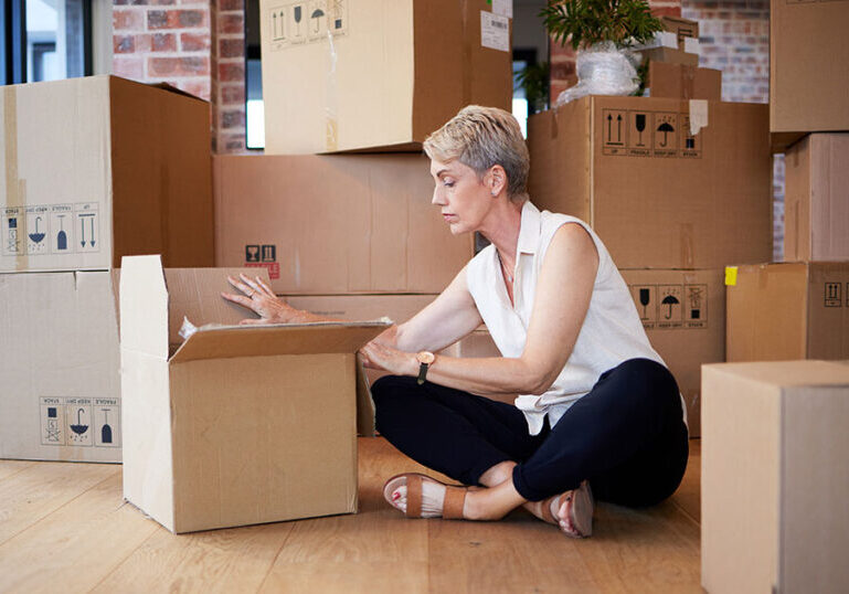 Woman unpacking boxes while moving.