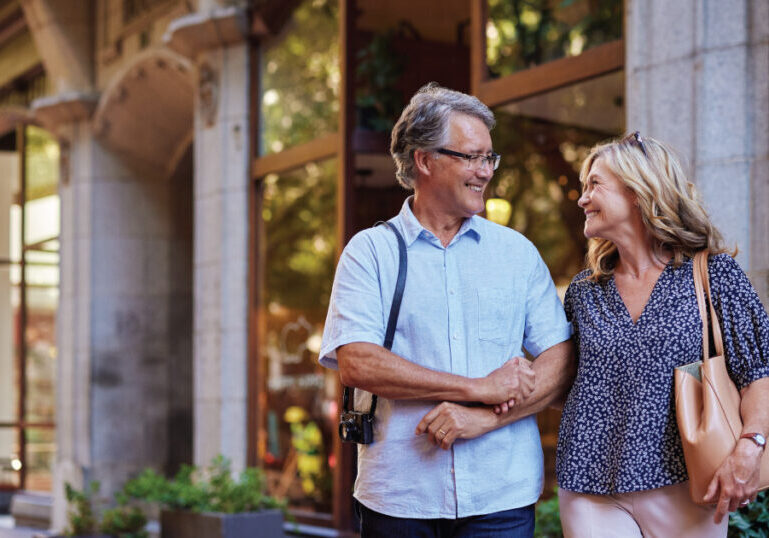 Couple walking outside in shopping district