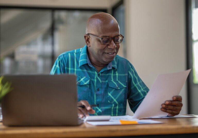 Older man researching on computer