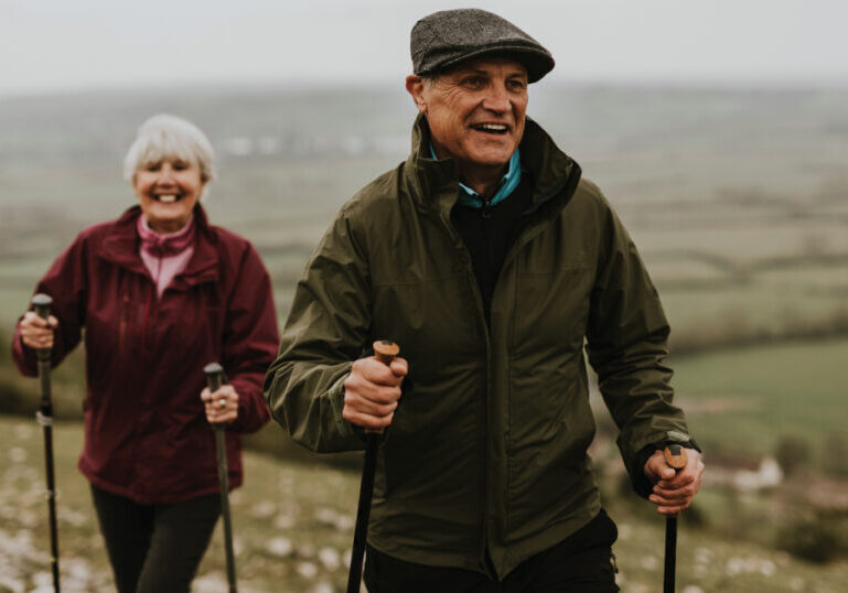 Older couple hiking in countryside