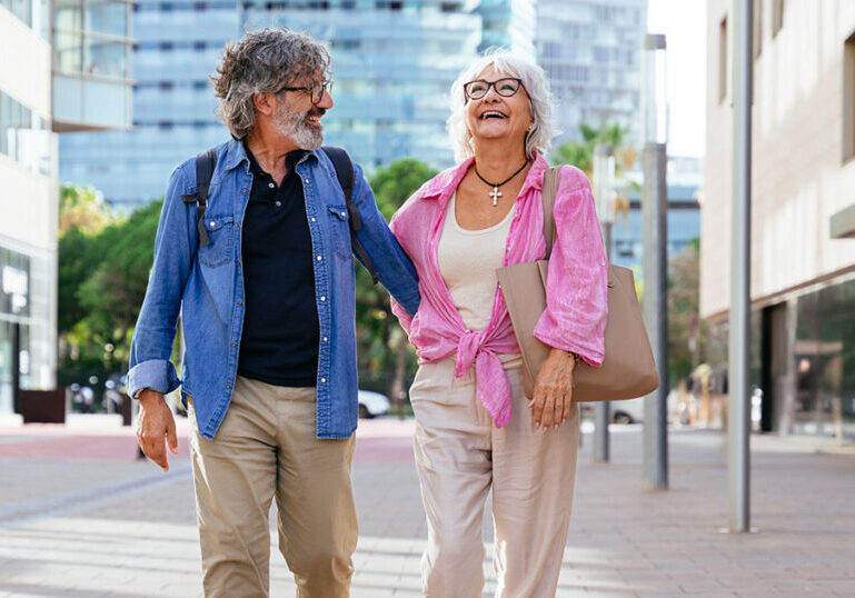 Older couple walking on city street