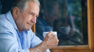 Man drinking coffee and considering retirement