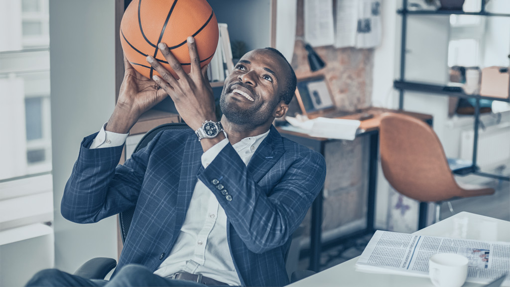 Athlete in office with basketball during meeting