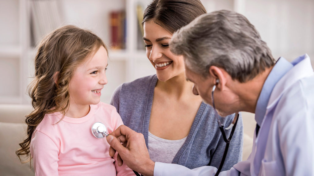 Pediatrician checks breath stethoscope a little girl in the arms of mother.