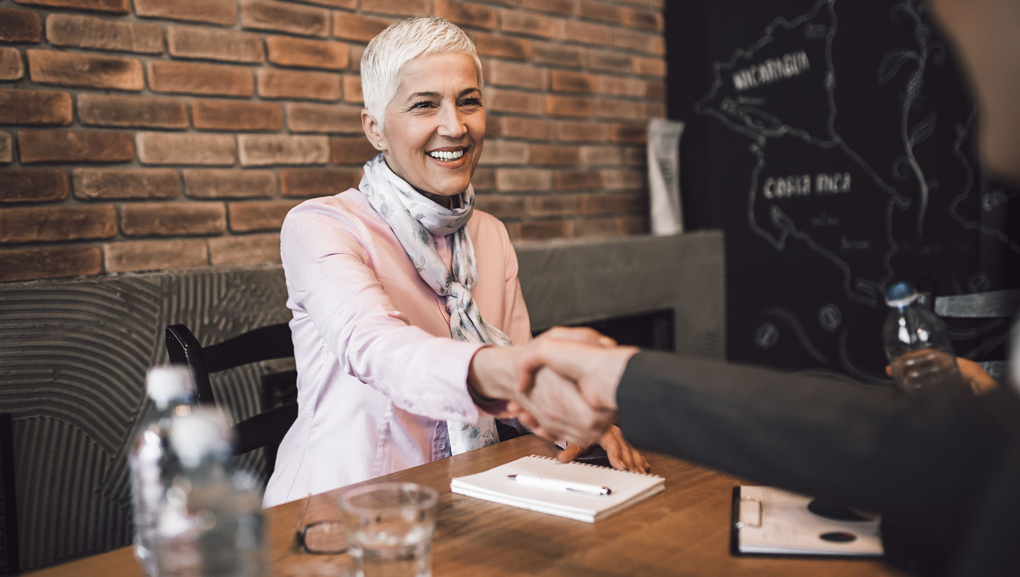 Woman shaking hands and accepting job offer