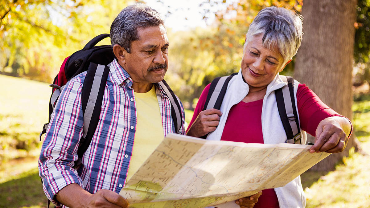 Mature hiking couple looking at a map