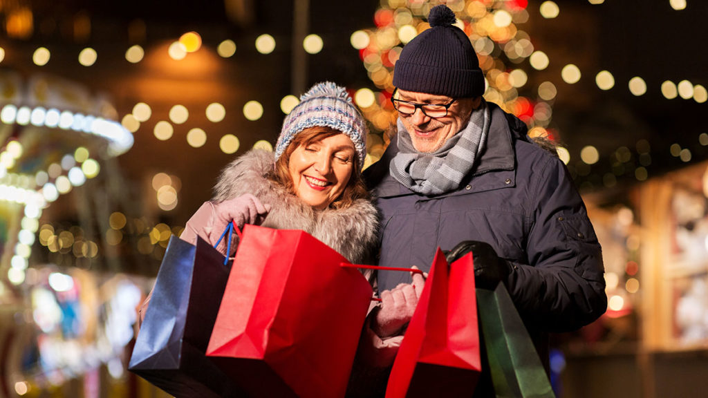 senior couple at Christmas market with shopping bags