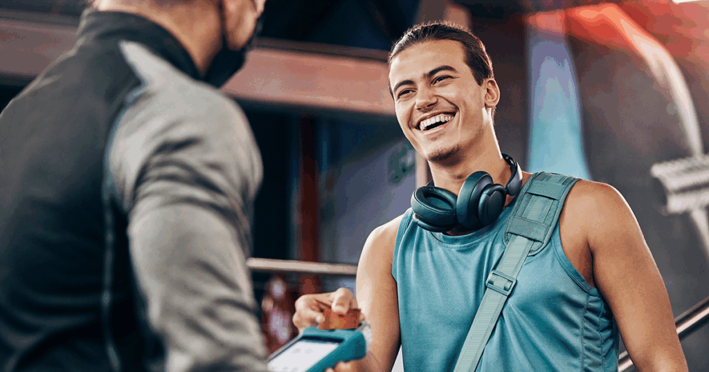 Man leaving gym and talking to a business man