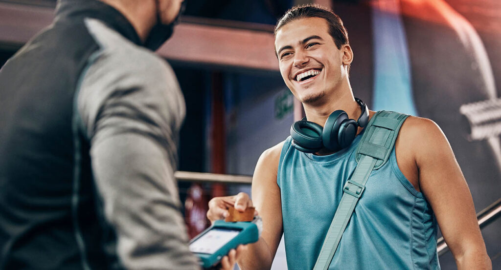 Men, credit card machine or payment in gym membership, personal trainer access or fitness coaching subscription. Banking device, nfc or cashless transaction or happy, smile or training sports athlete.