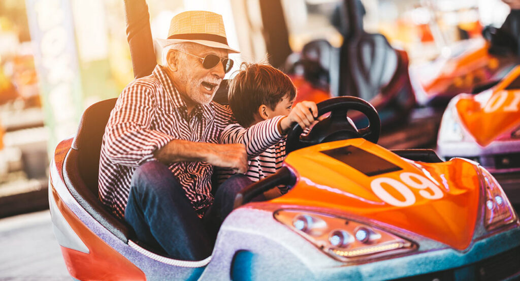 Grandfather and grandson enjoying an amusement park