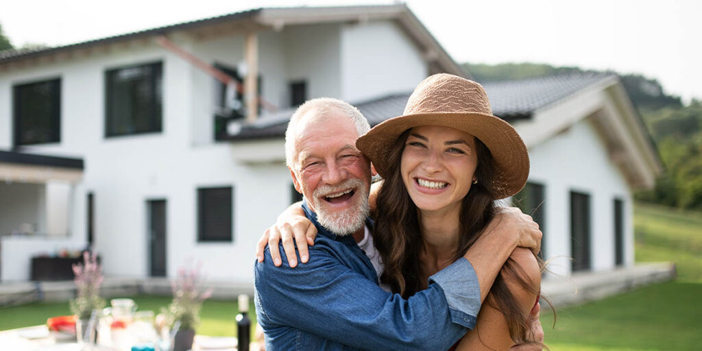 Senior father hugs daughter who will inherit the family home