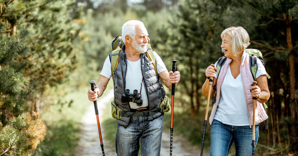 Senior couple talks about tax-loss harvesting while on hike