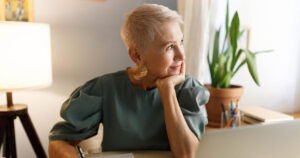 Thoughtful senior woman considers the concept of opportunity cost