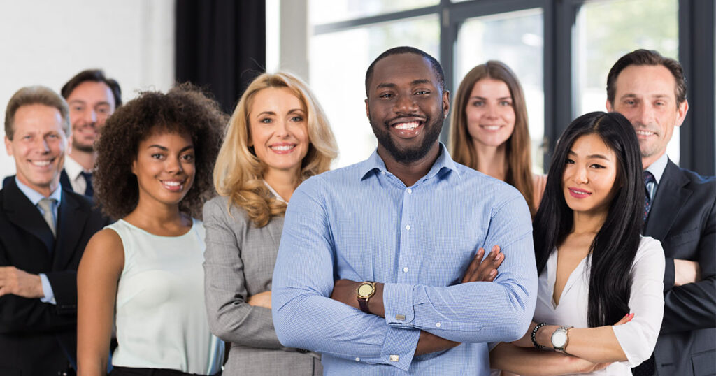 group of employees smiling at office space
