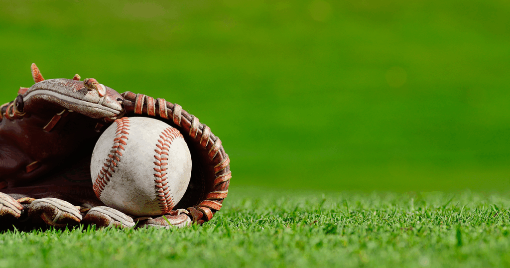 baseball glove with ball, lying on field
