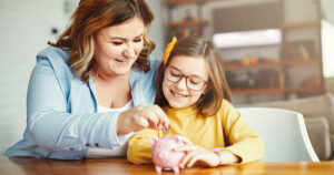 Mother teaches her young daughter about money