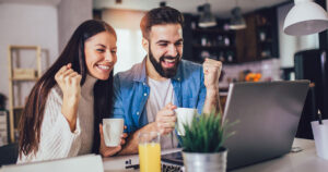 Happy couple looking at their positive financial results