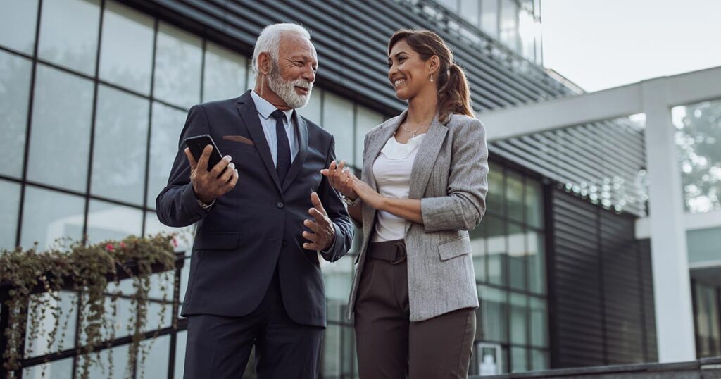 Financial advisor and client discussing real estate tax strategy outside a modern office building