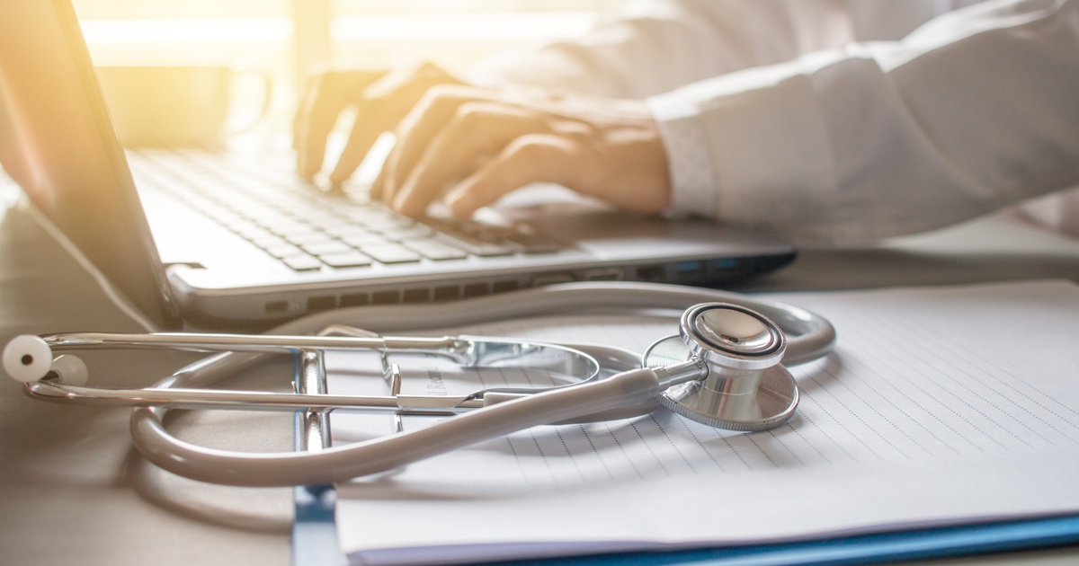 Stethoscope beside a laptop representing healthcare costs and retirement planning image