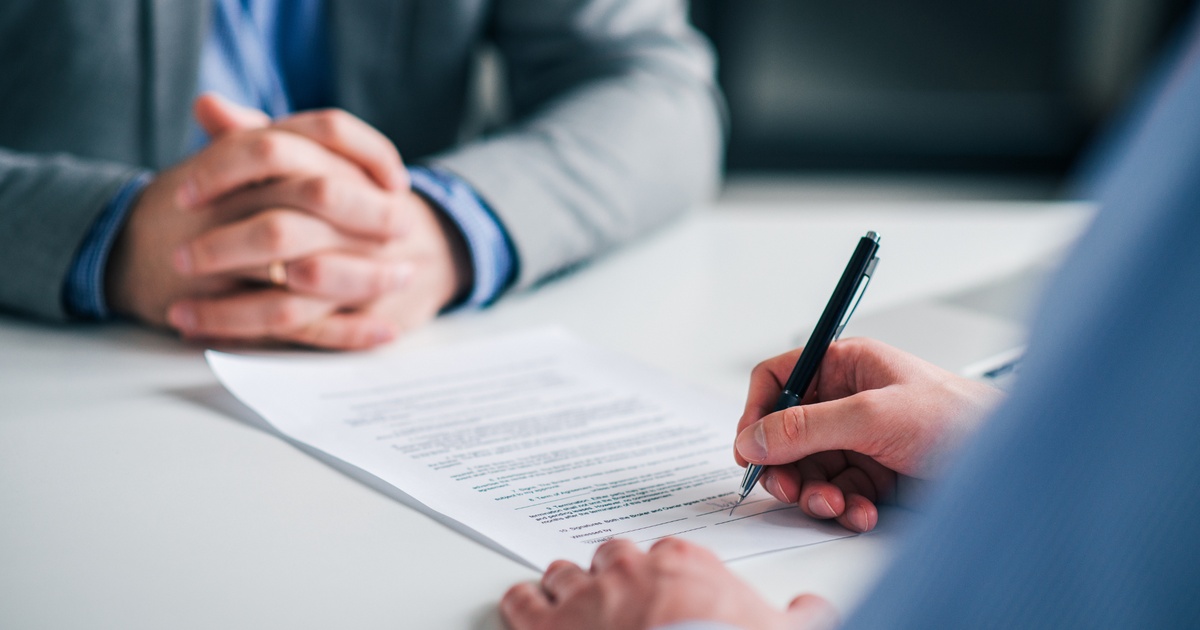 Physician mortgage paperwork being reviewed and signed during a home financing meeting image