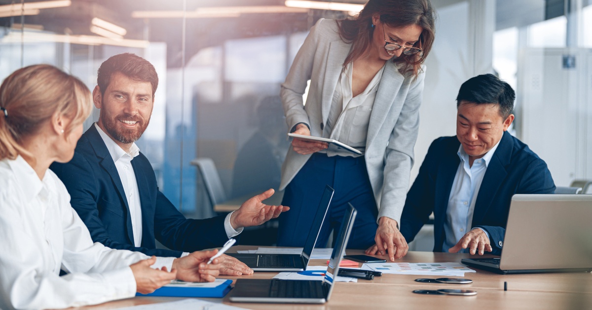 Corporate executives reviewing financial data together in a conference room, reflecting the complexity of executive compensation and wealth decisions
