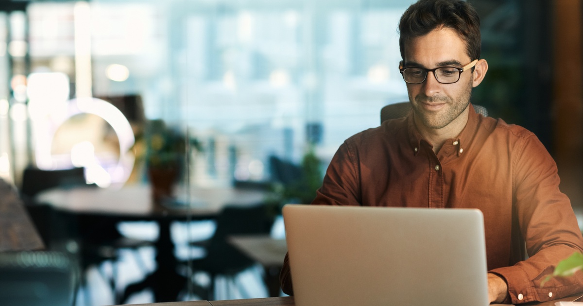 Professional working on a laptop, focusing on personalized equity and financial planning scenarios.