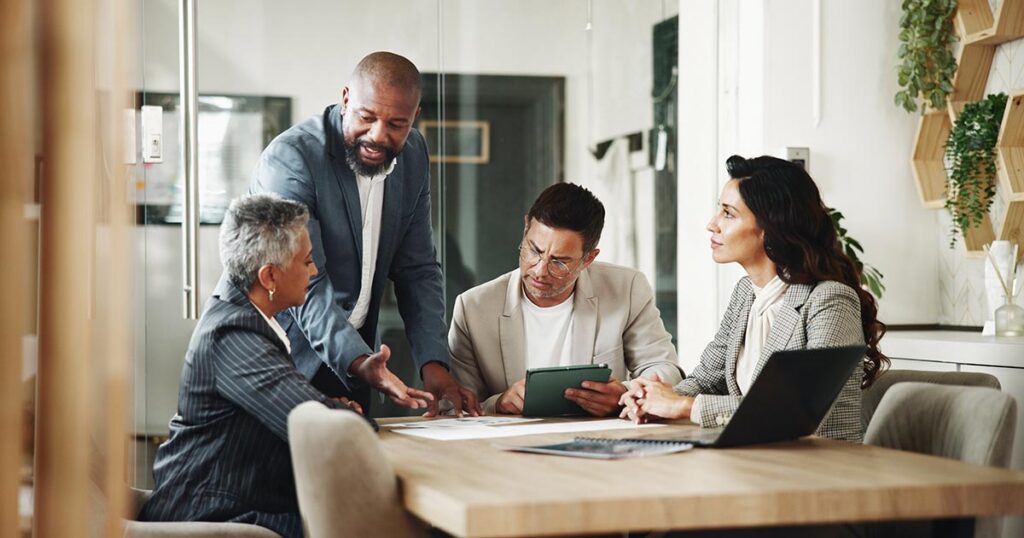 Advisory team meeting with a high‑net‑worth client to review complex trust structures, fiduciary duties and multigenerational estate planning strategies