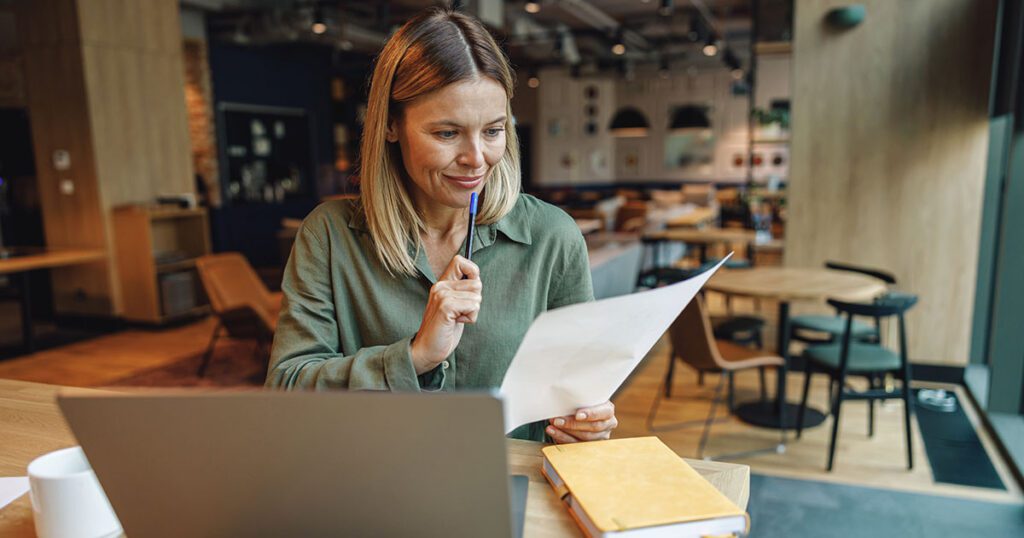 Business owner reviewing financial statements and balance sheet records for year-end tax planning