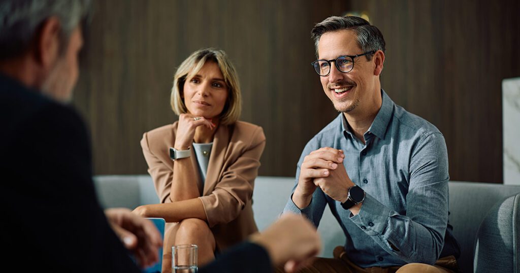Wealthy couple meeting with a financial advisor to discuss multifamily office wealth planning