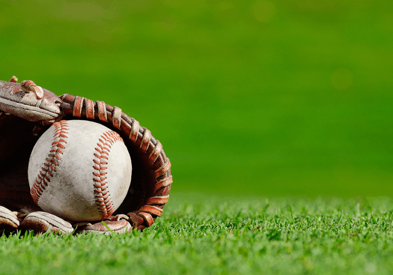 baseball glove with ball, lying on field