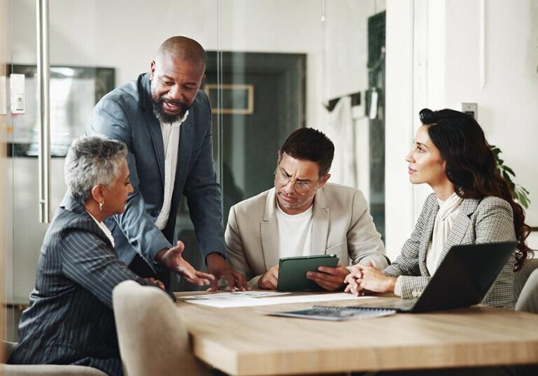 Advisory team meeting with a high‑net‑worth client to review complex trust structures, fiduciary duties and multigenerational estate planning strategies