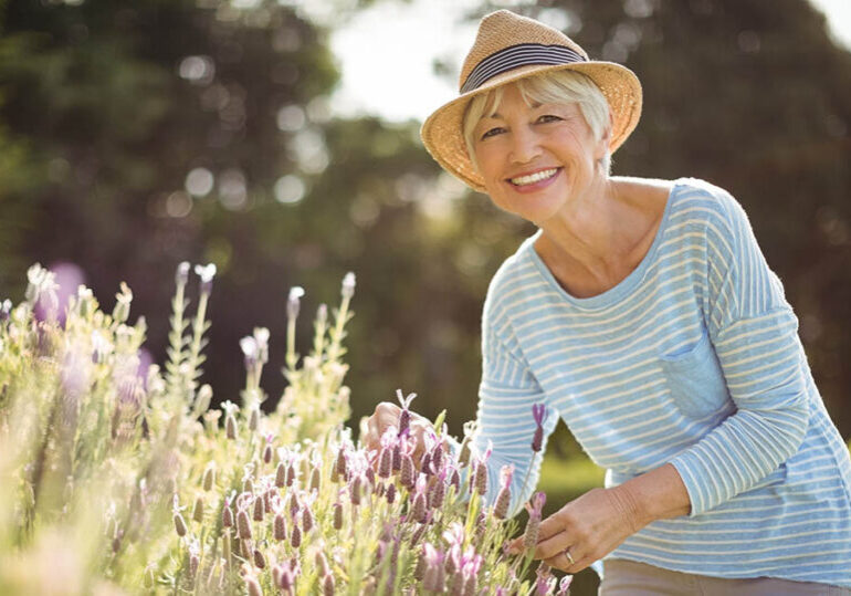 Happy senior woman ponders how to create a retirement paycheck