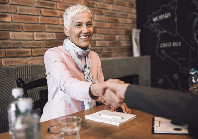 Woman shaking hands and accepting job offer