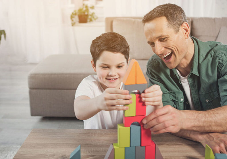 Father and son build a block tower