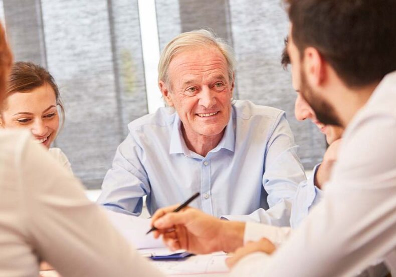 Mature businessman works with his succession planning advisors
