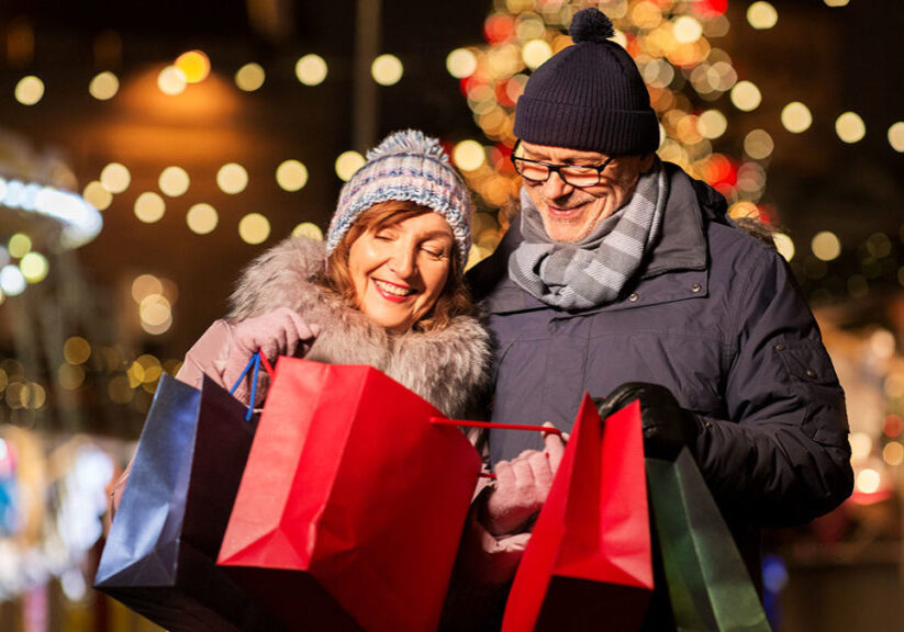senior couple at Christmas market with shopping bags