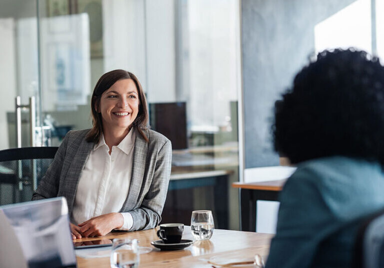 Advisor meeting with a client to discuss tax‑loss harvesting strategies, illustrating how selling losing investments to offset gains can improve a portfolio’s after‑tax returns