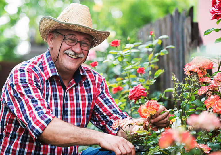Man pauses gardening to hear facts about RMDs