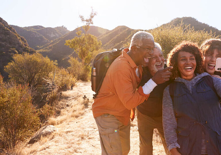 Group of senior friends goes hiking and discusses trends changing retirement