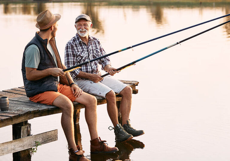 Man and his adult son fish together